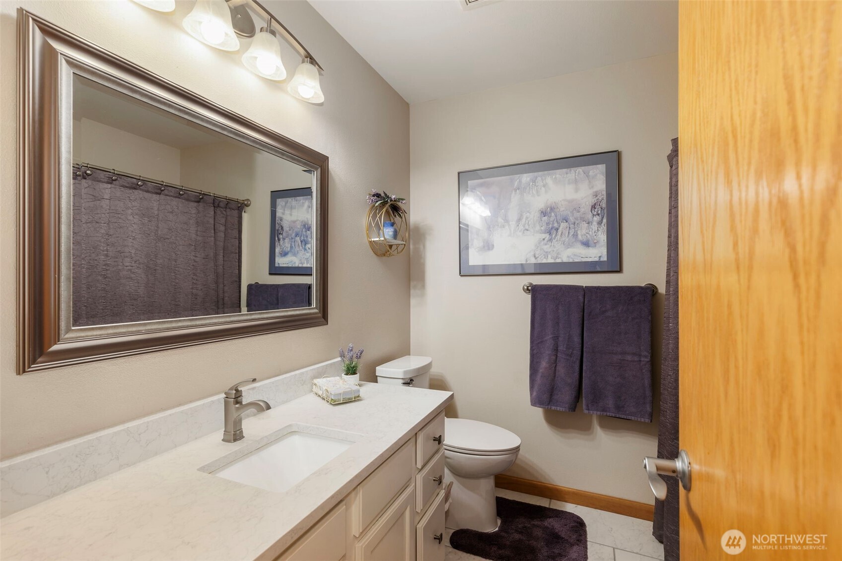 9240 Priddy Vista Road Northwest Seabeck, WA 98380 - Photo 23 of 40 a bathroom with a toilet sink and mirror