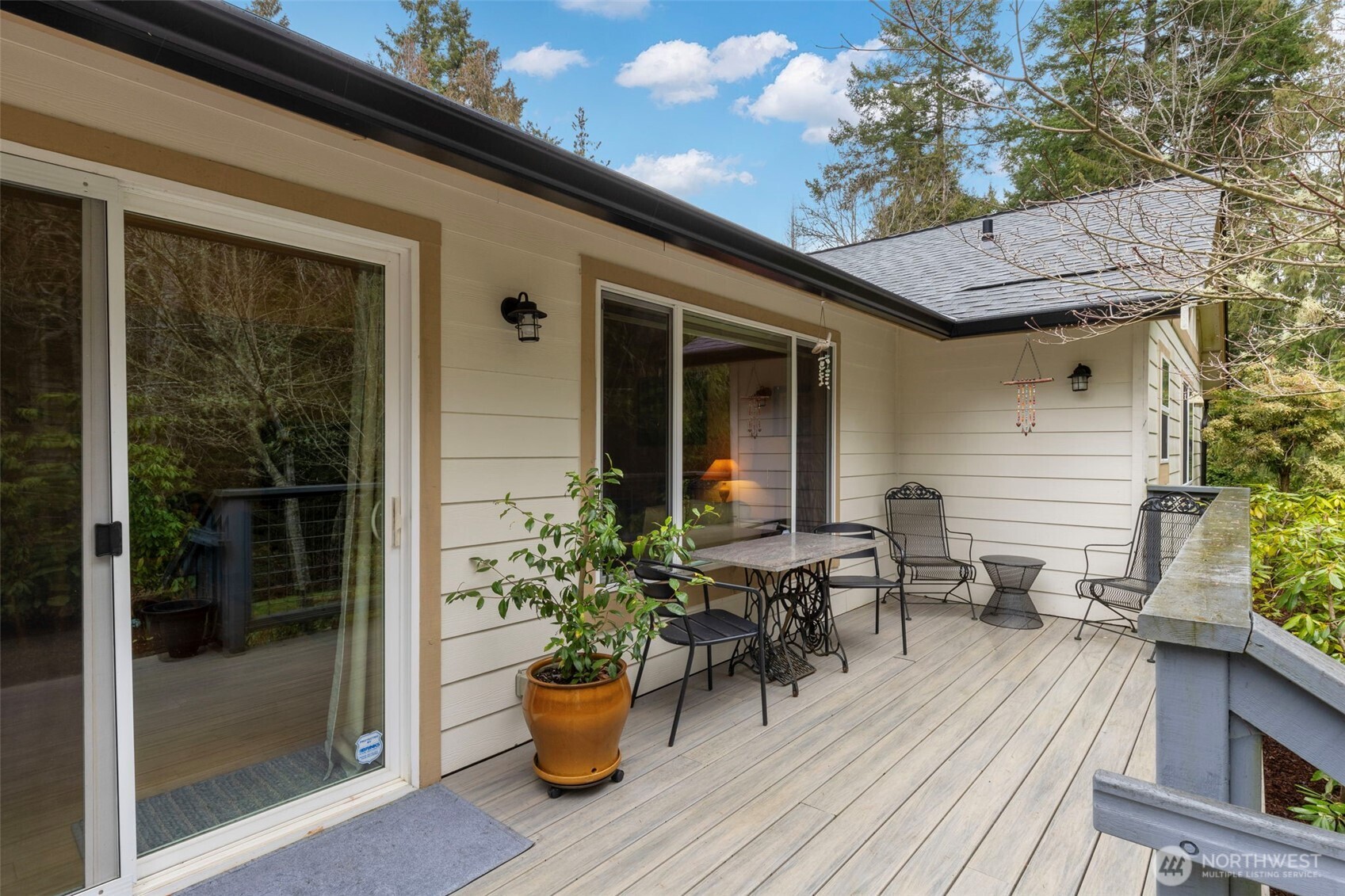 9240 Priddy Vista Road Northwest Seabeck, WA 98380 - Photo 24 of 40 a view of a patio with chairs and potted plants