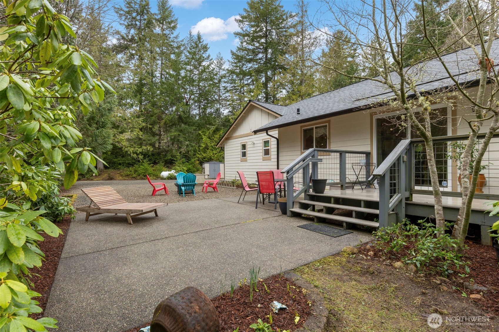 9240 Priddy Vista Road Northwest Seabeck, WA 98380 - Photo 26 of 40 a front view of a house with a garden