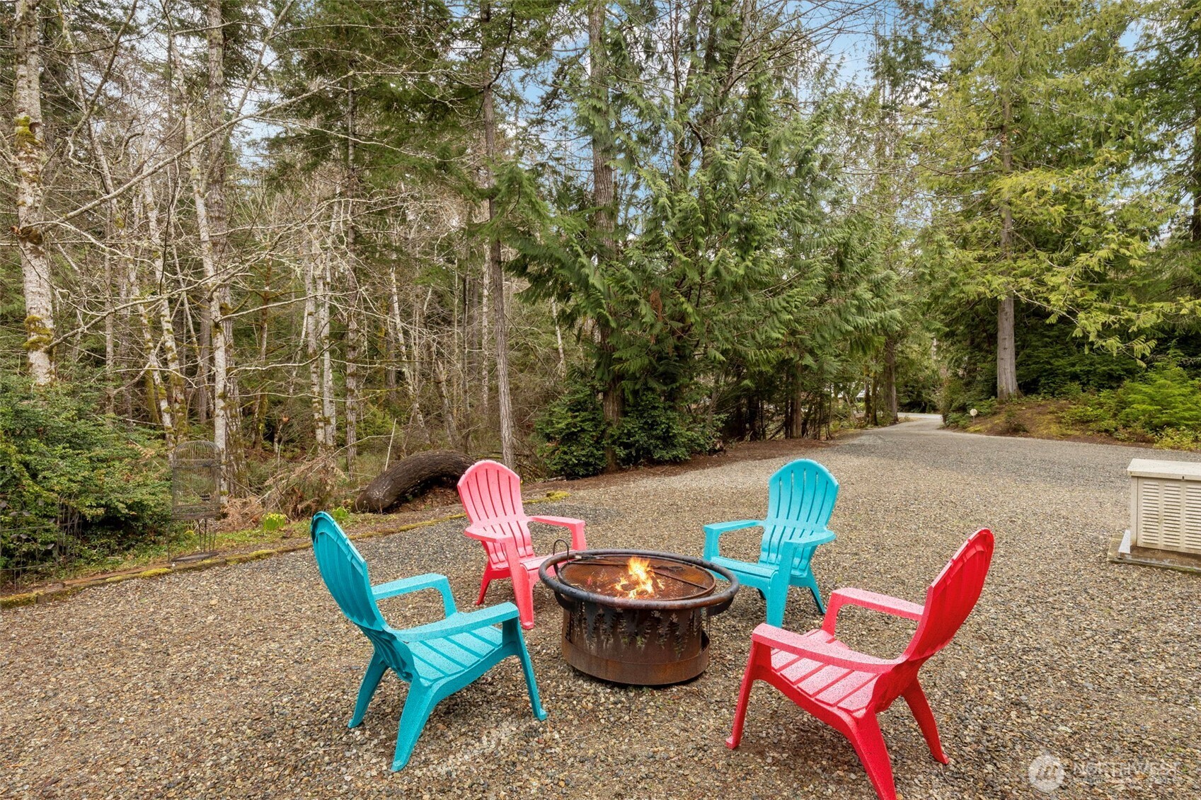 9240 Priddy Vista Road Northwest Seabeck, WA 98380 - Photo 28 of 40 a backyard of a house with a table and chairs