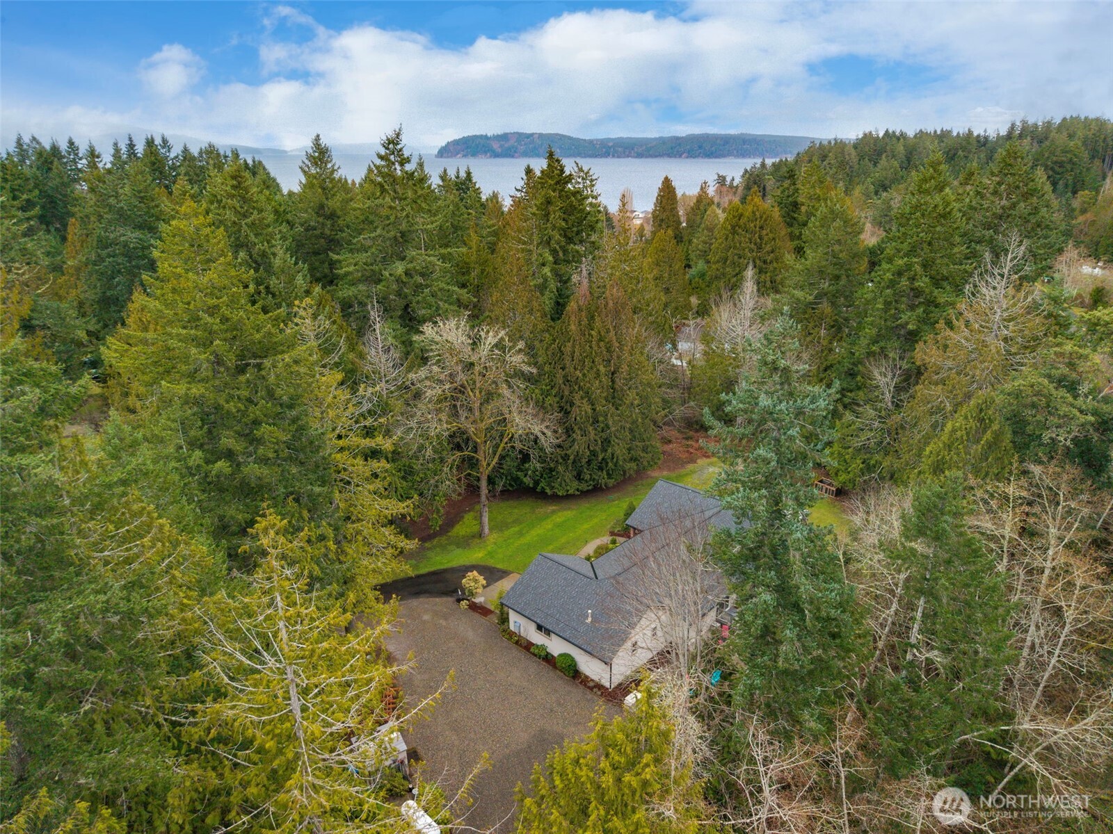 9240 Priddy Vista Road Northwest Seabeck, WA 98380 - Photo 39 of 40 an aerial view of a house with a yard