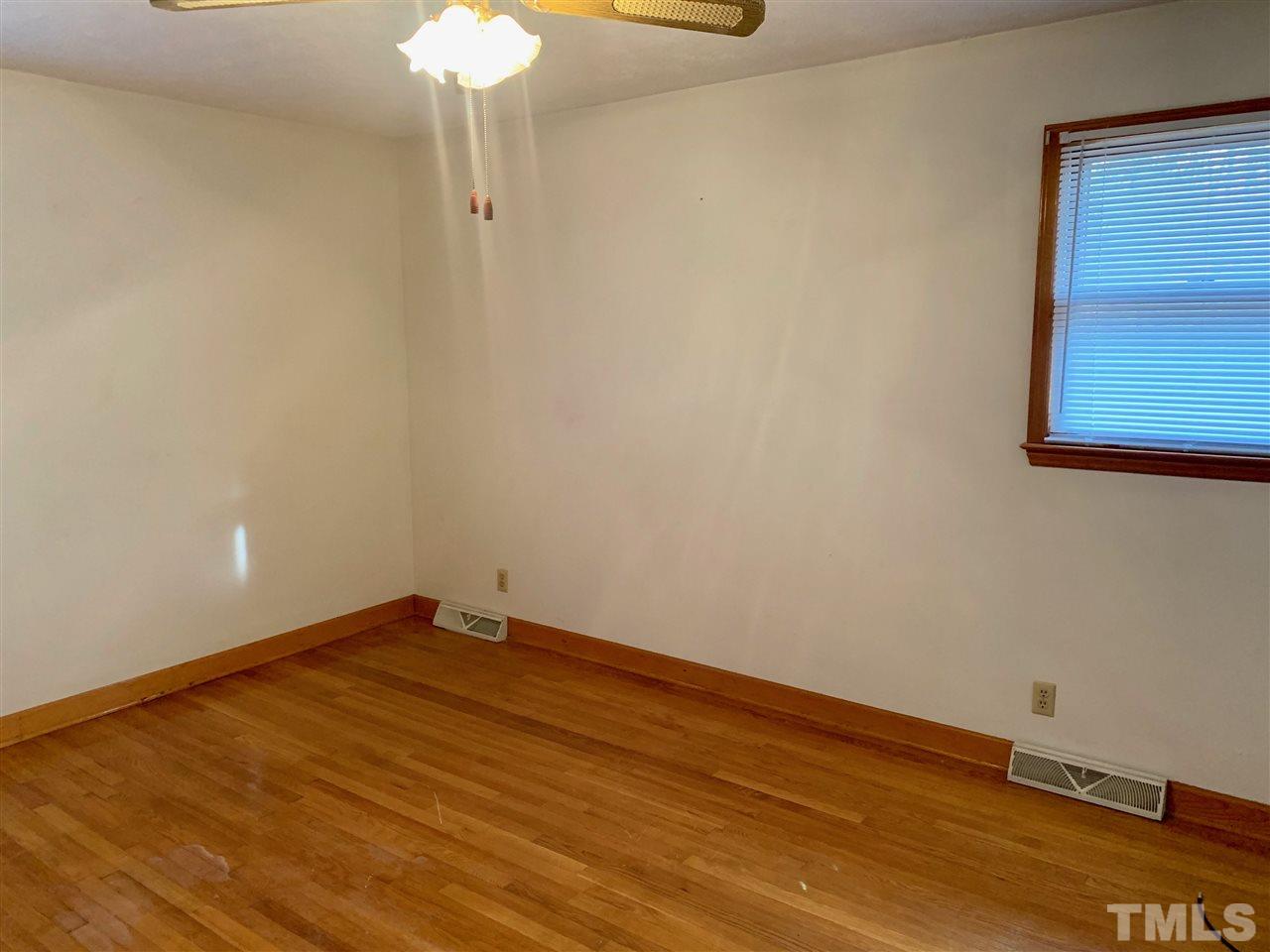 300 Thomas Humphries Road Roxboro, NC 27574 - Photo 14 of 22 Master bedroom suite has hardwood floors and private bathroom with a shower.