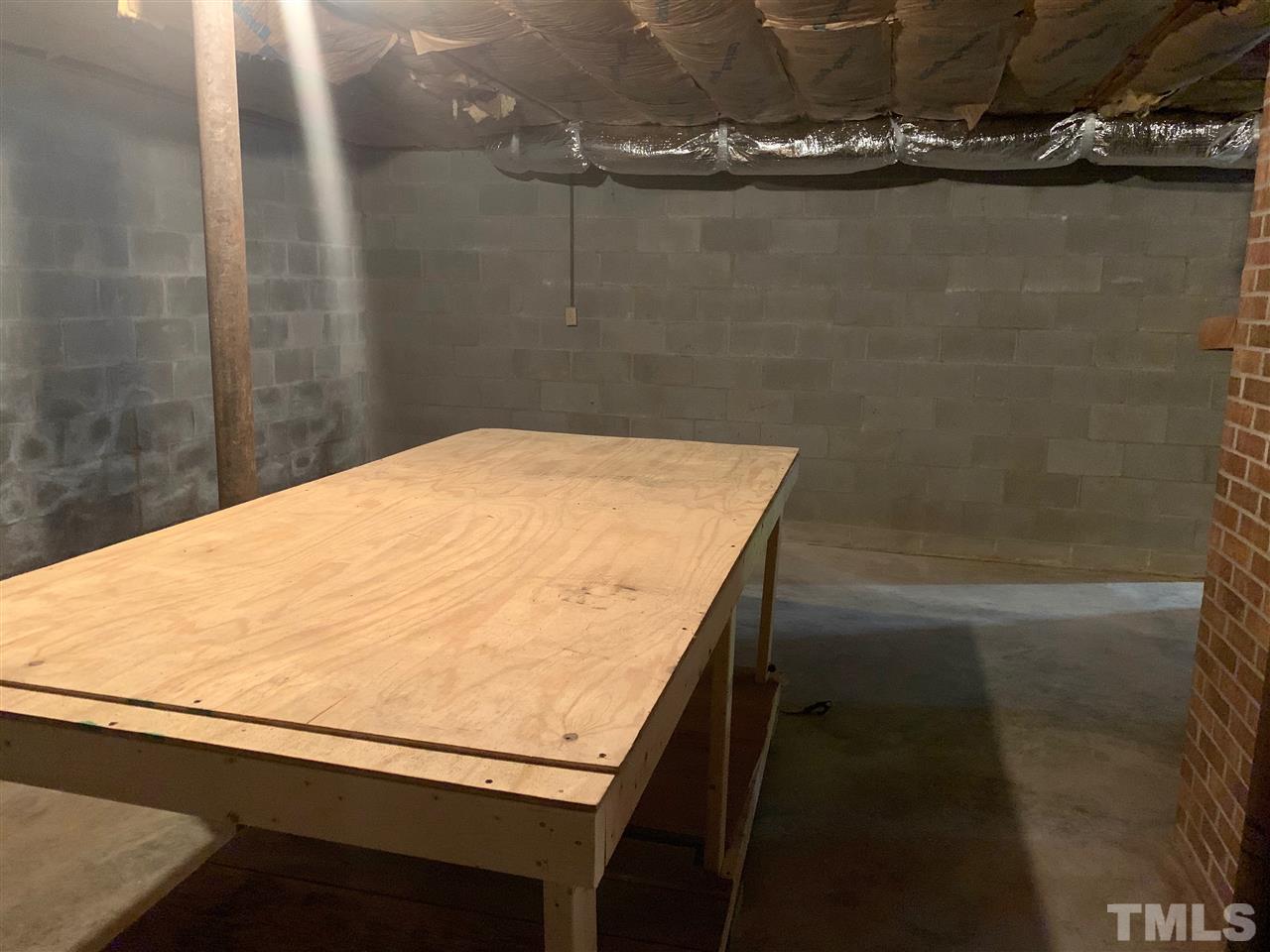 300 Thomas Humphries Road Roxboro, NC 27574 - Photo 17 of 22 There are several work tables in the basement with abundant outlets for access to electricity.