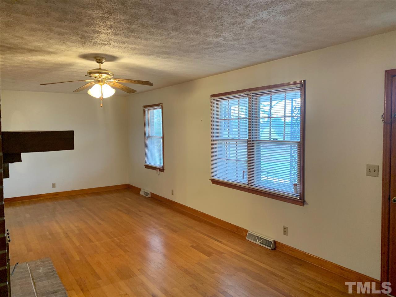 300 Thomas Humphries Road Roxboro, NC 27574 - Photo 7 of 22 Beautiful warm hardwoods in formal living room.