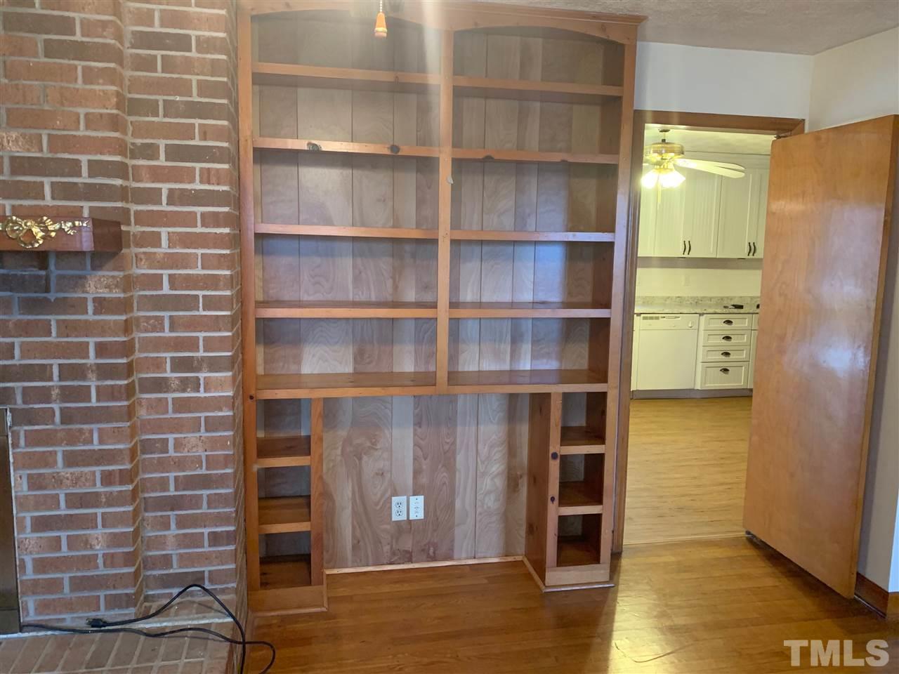300 Thomas Humphries Road Roxboro, NC 27574 - Photo 8 of 22 Built-in wooden bookshelves in living room.