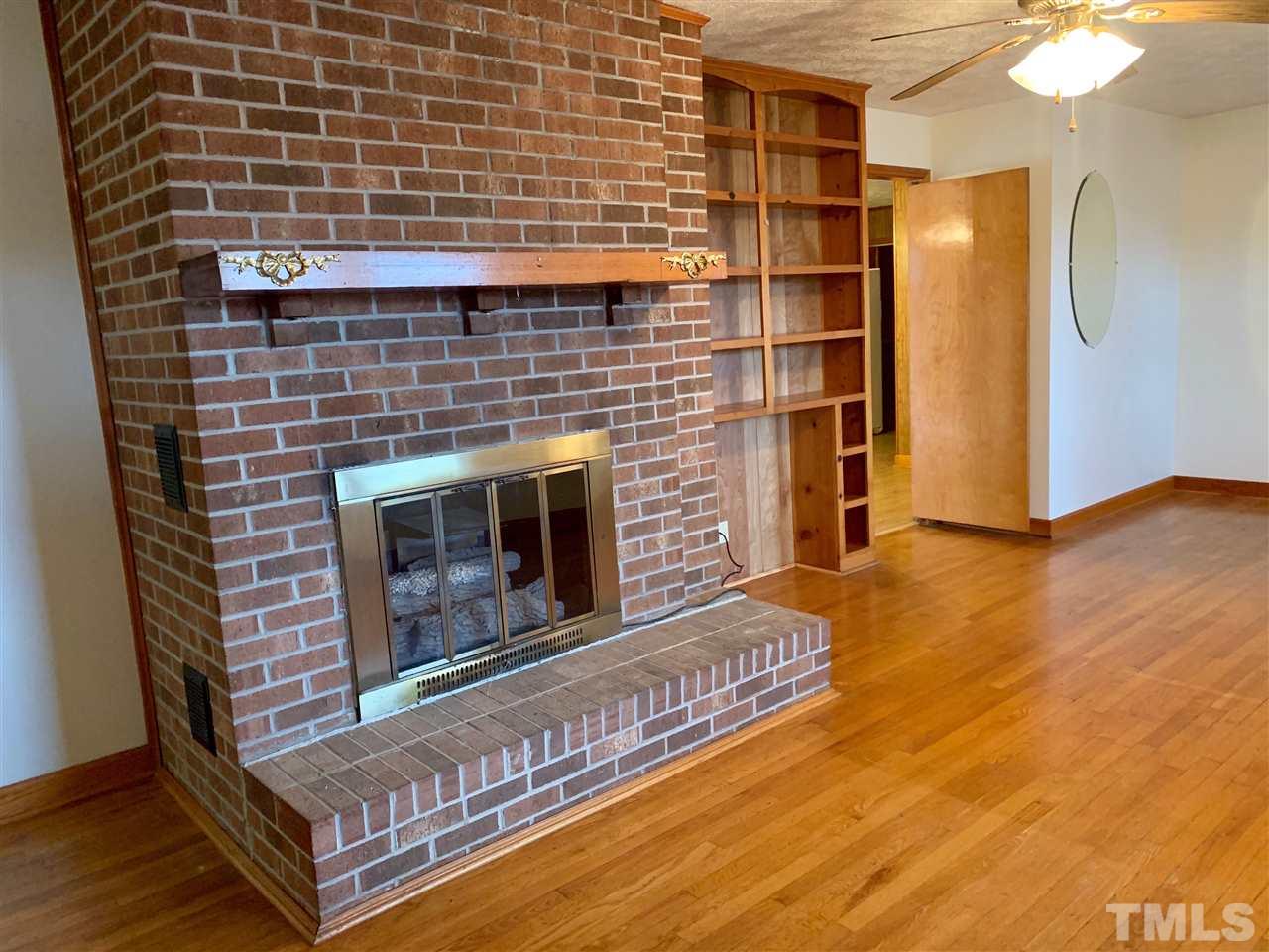300 Thomas Humphries Road Roxboro, NC 27574 - Photo 10 of 22 Beautiful brick fireplace in living room. No need for firewood. Fireplace is electric.