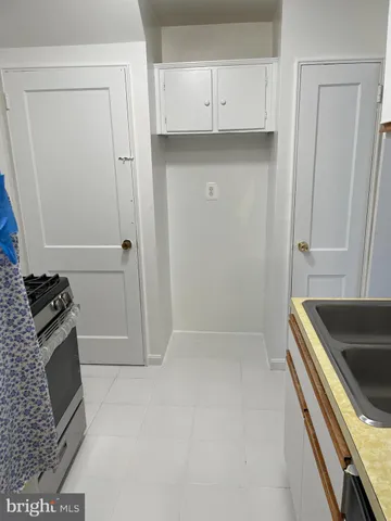 a kitchen with white cabinets and a stove
