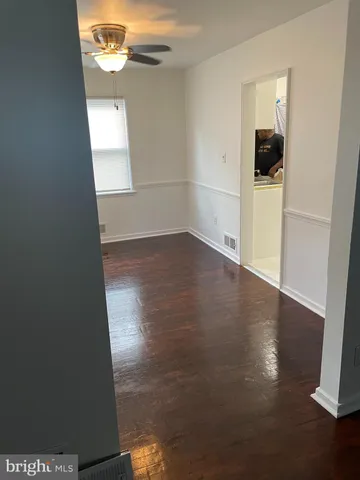 an empty room with wooden floor and closet