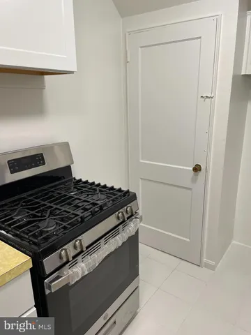 a stove top oven sitting inside of a kitchen