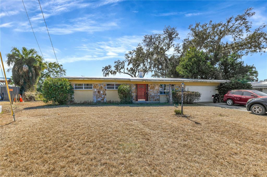 310 Kenmore Road Brandon, FL 33511 - Photo 2 of 33 a view of a house with a yard and garage