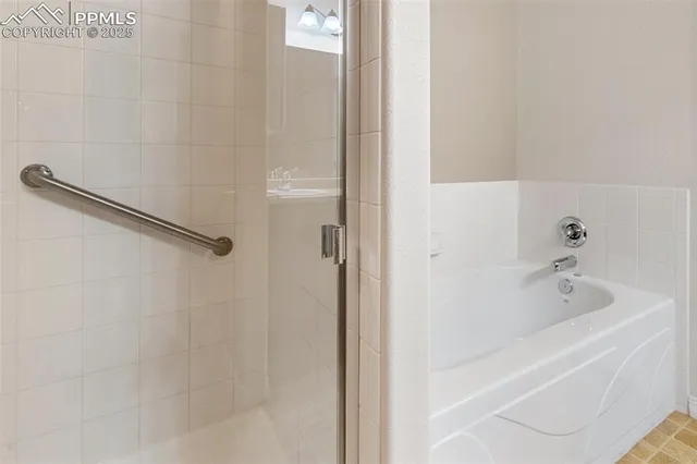a bathroom with a tub and a shower