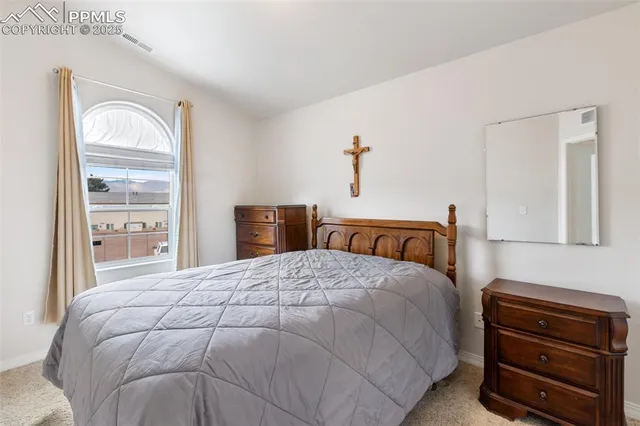 a bedroom with a bed and a dresser