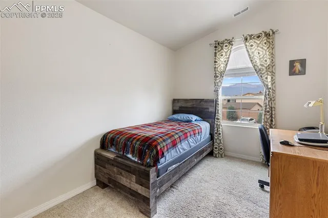 a spacious bedroom with a bed and a window