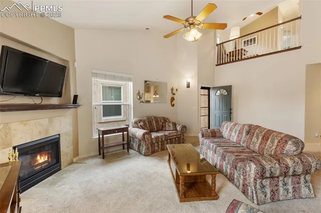 a living room with furniture a flat screen tv and a fireplace