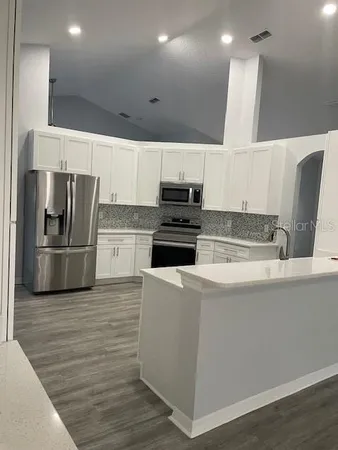 a kitchen with wooden cabinets and stainless steel appliances