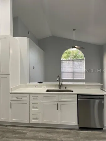 a kitchen with a sink cabinets and chandelier