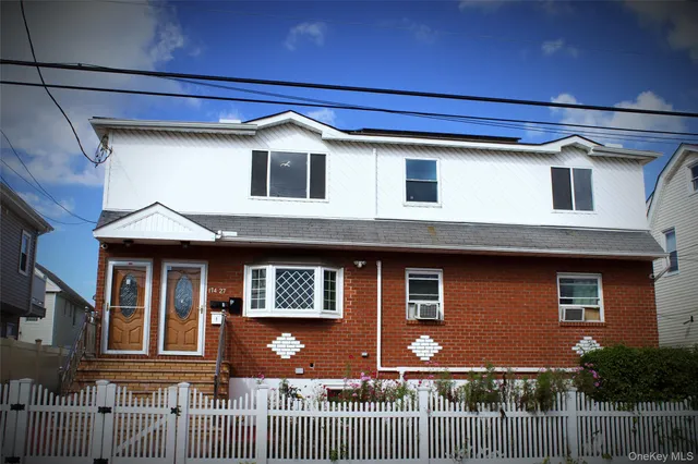 a front view of a house with a fence