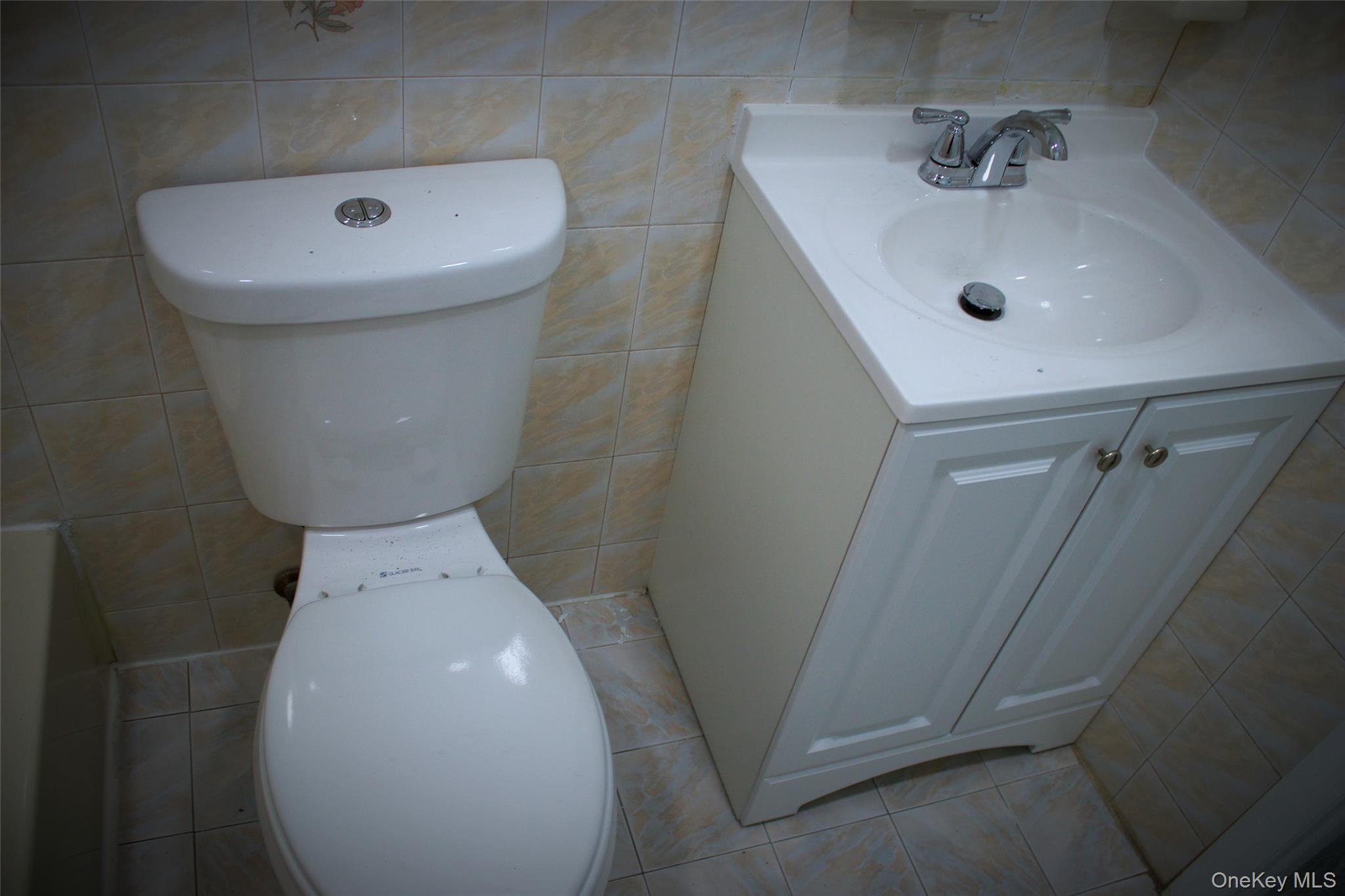 174-27 126th Avenue, Unit 2 Queens, NY 11434 - Photo 12 of 12 a bathroom with a sink a toilet and shower