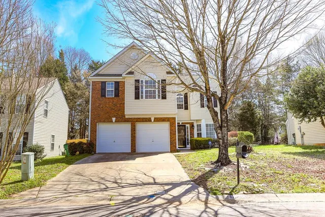 a front view of a house with a yard