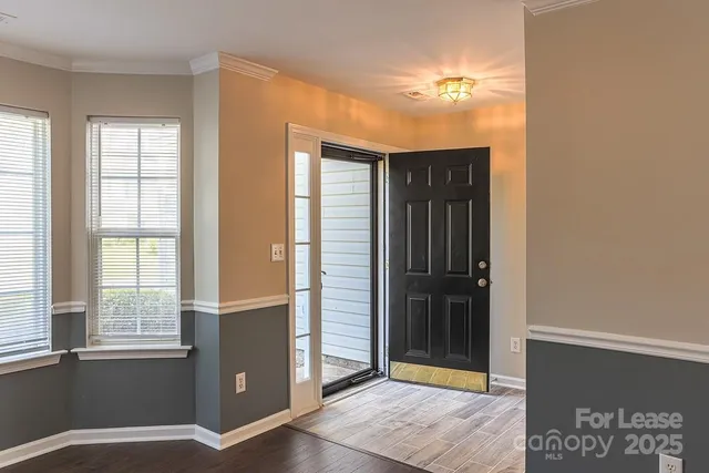 a view of a hallway with wooden floor and a fireplace