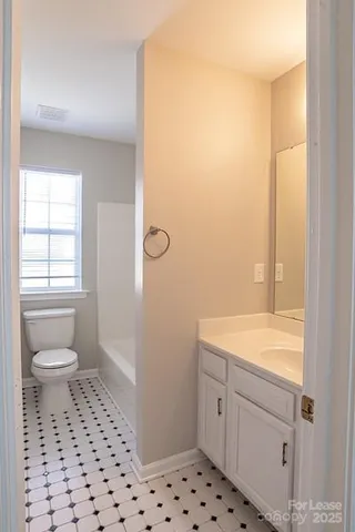 a view of backyard with table and chairs and wooden fence