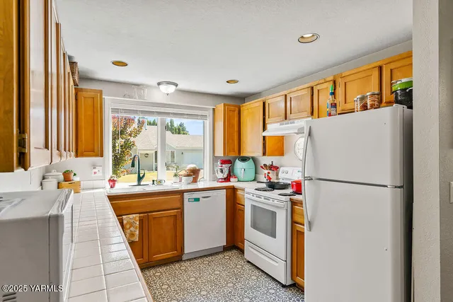 a kitchen with a sink and white cabinets