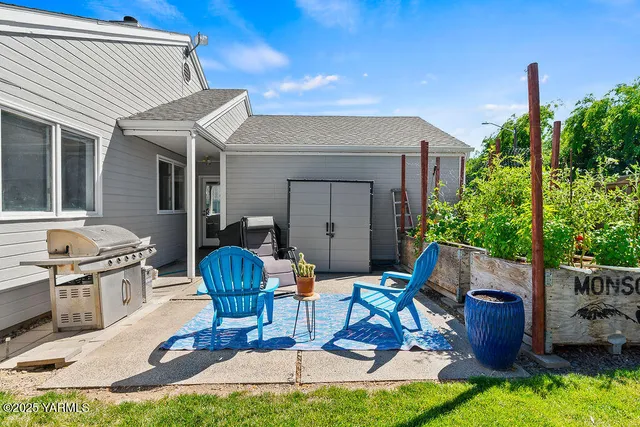 a view of house with backyard and outdoor seating