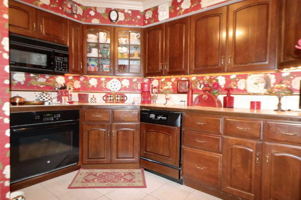 6033 North Sheridan Road, Unit 30A Chicago, IL 60660 - Photo 22 of 50 a kitchen with stainless steel appliances granite countertop wooden cabinets and a stove top oven