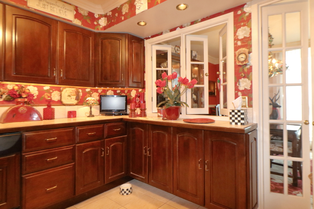 6033 North Sheridan Road, Unit 30A Chicago, IL 60660 - Photo 23 of 50 a kitchen with a sink and wooden cabinets