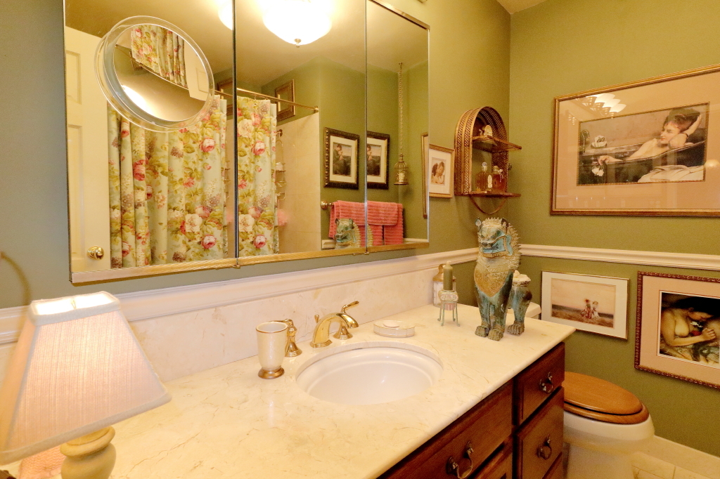 6033 North Sheridan Road, Unit 30A Chicago, IL 60660 - Photo 40 of 50 a bathroom with a granite countertop sink and a mirror