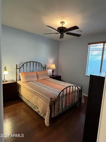 a bed sitting in a bedroom next to a window