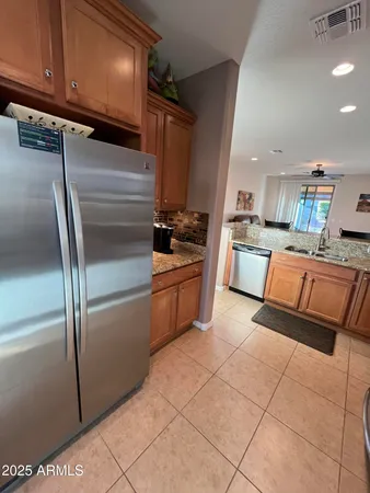 a kitchen with stainless steel appliances granite countertop a refrigerator sink and cabinets