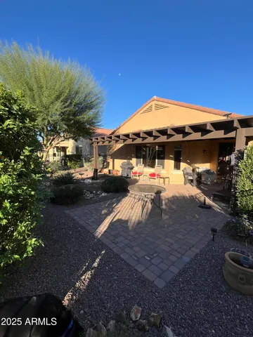 a view of a backyard with table and chairs