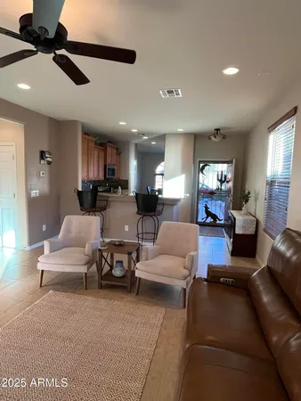 a living room with furniture and a ceiling fan