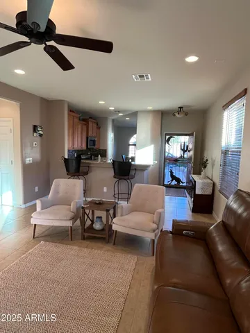 a living room with furniture and a ceiling fan