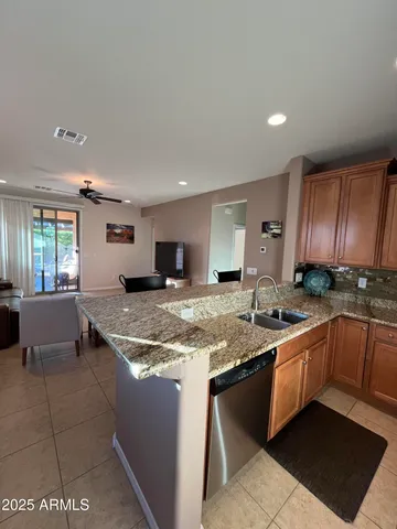 a kitchen with stainless steel appliances granite countertop a sink and a stove