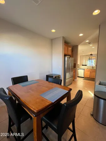 a outdoor dining space with furniture and a view of kitchen