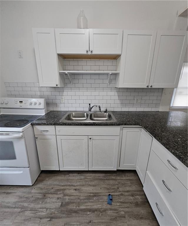 16 Johnson Street Cartersville, GA 30120 - Photo 4 of 6 a kitchen with granite countertop white cabinets and white appliances
