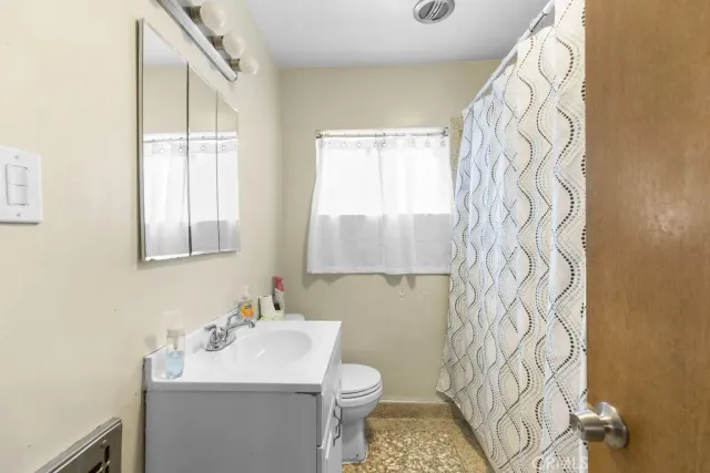 a bathroom with a sink toilet and mirror