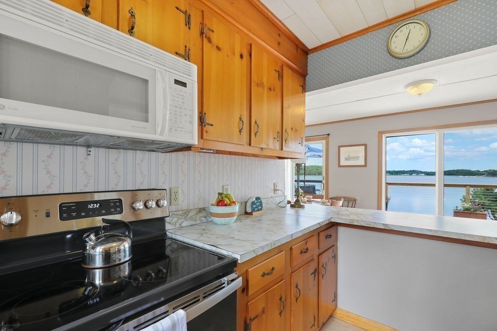 14 Salt Marsh Lane Wareham, MA 02571 - Photo 15 of 42 a kitchen with stainless steel appliances granite countertop a stove and a sink