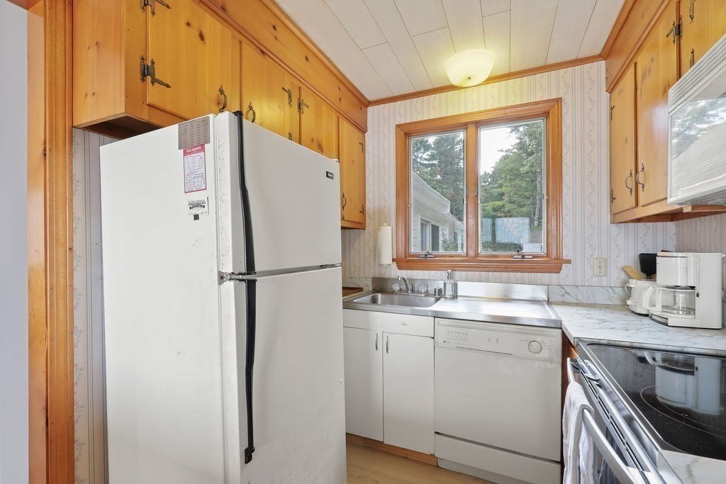 14 Salt Marsh Lane Wareham, MA 02571 - Photo 16 of 42 a white refrigerator freezer sitting in a kitchen