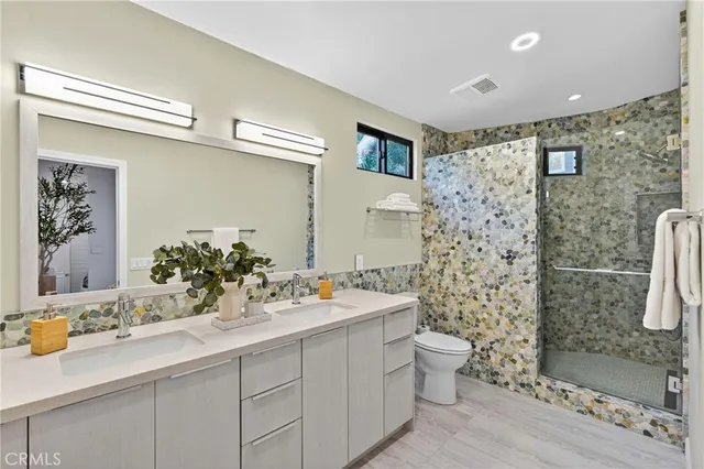 a bathroom with a sink mirror and toilet