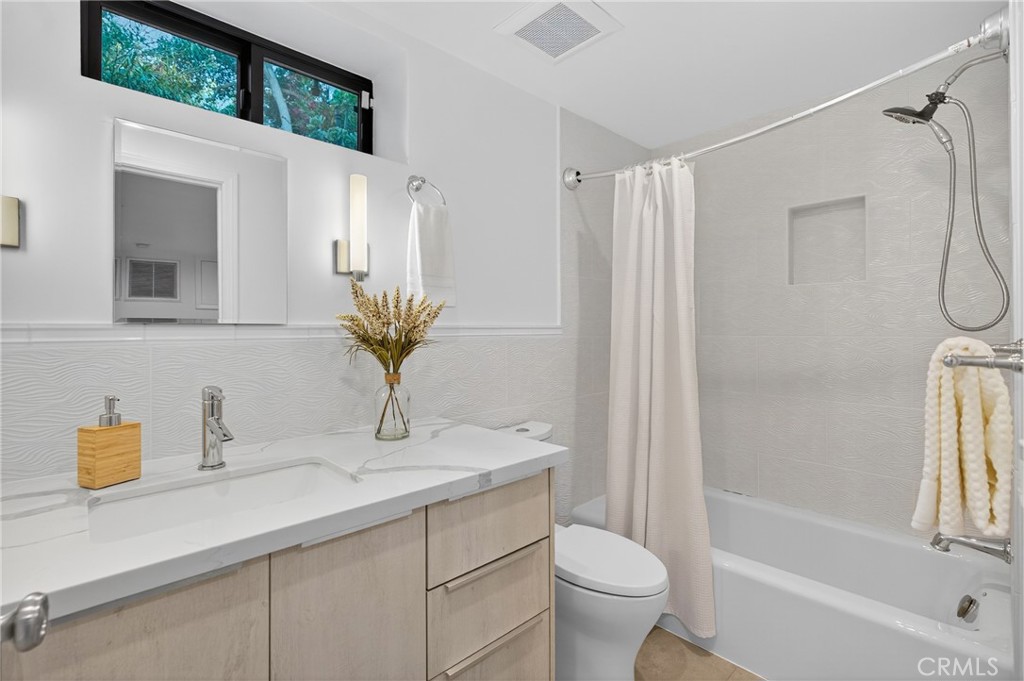 7580 McGroarty Terrace Los Angeles, CA 91042 - Photo 15 of 47 a bathroom with a granite countertop sink a toilet and shower