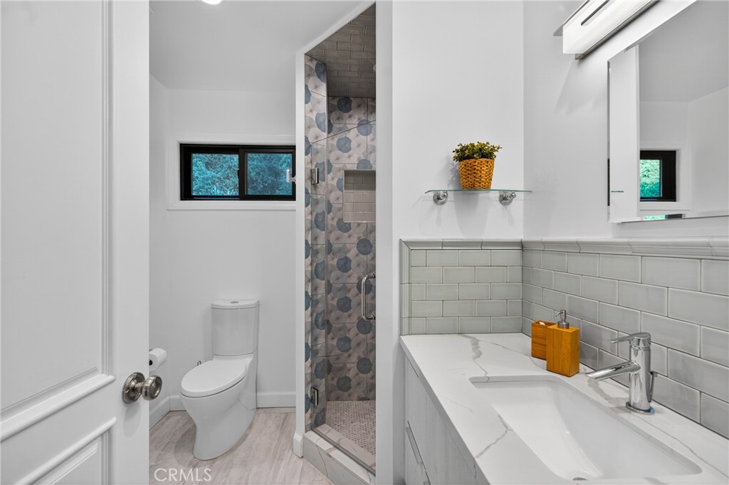 7580 McGroarty Terrace Los Angeles, CA 91042 - Photo 18 of 47 a bathroom with a sink a toilet and shower