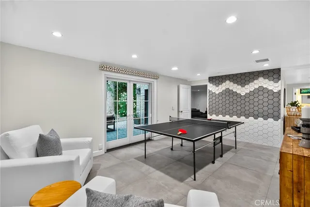 a living room with furniture a rug and a floor to ceiling window