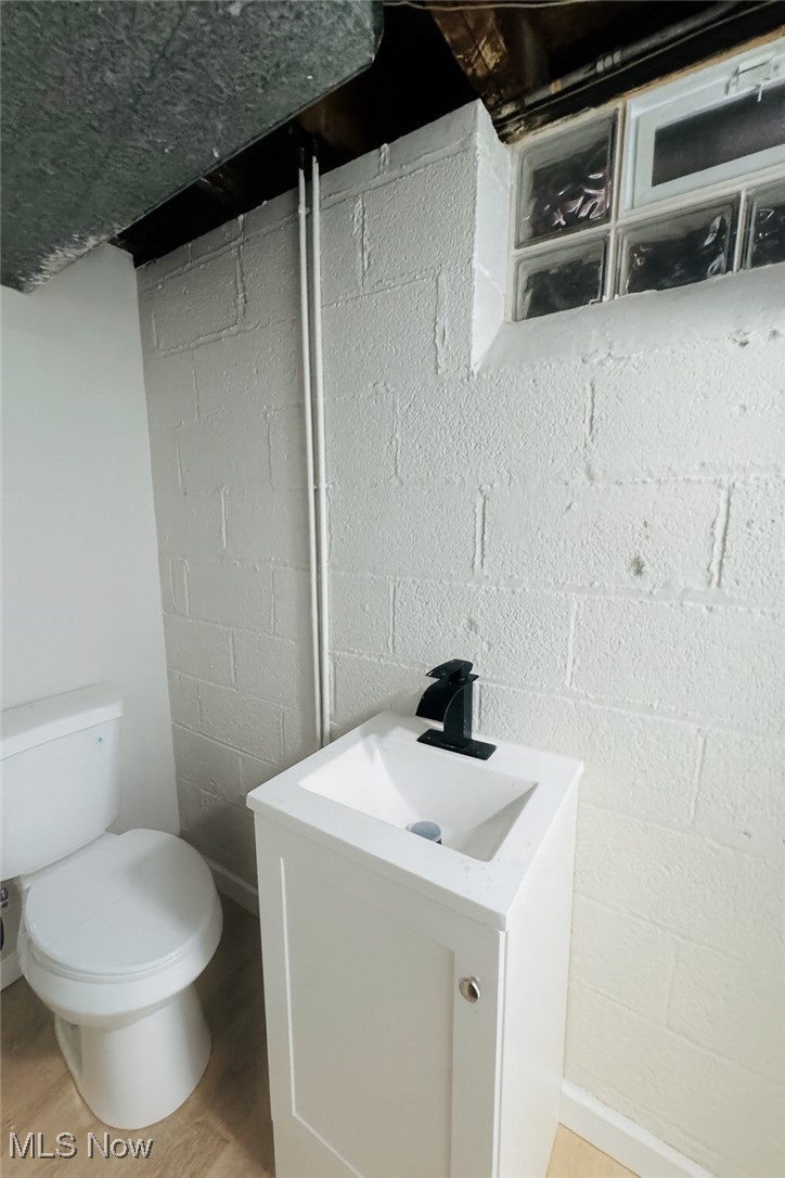 14505 Triskett Road Cleveland, OH 44111 - Photo 15 of 15 Half bath featuring vanity and light wood-style floors