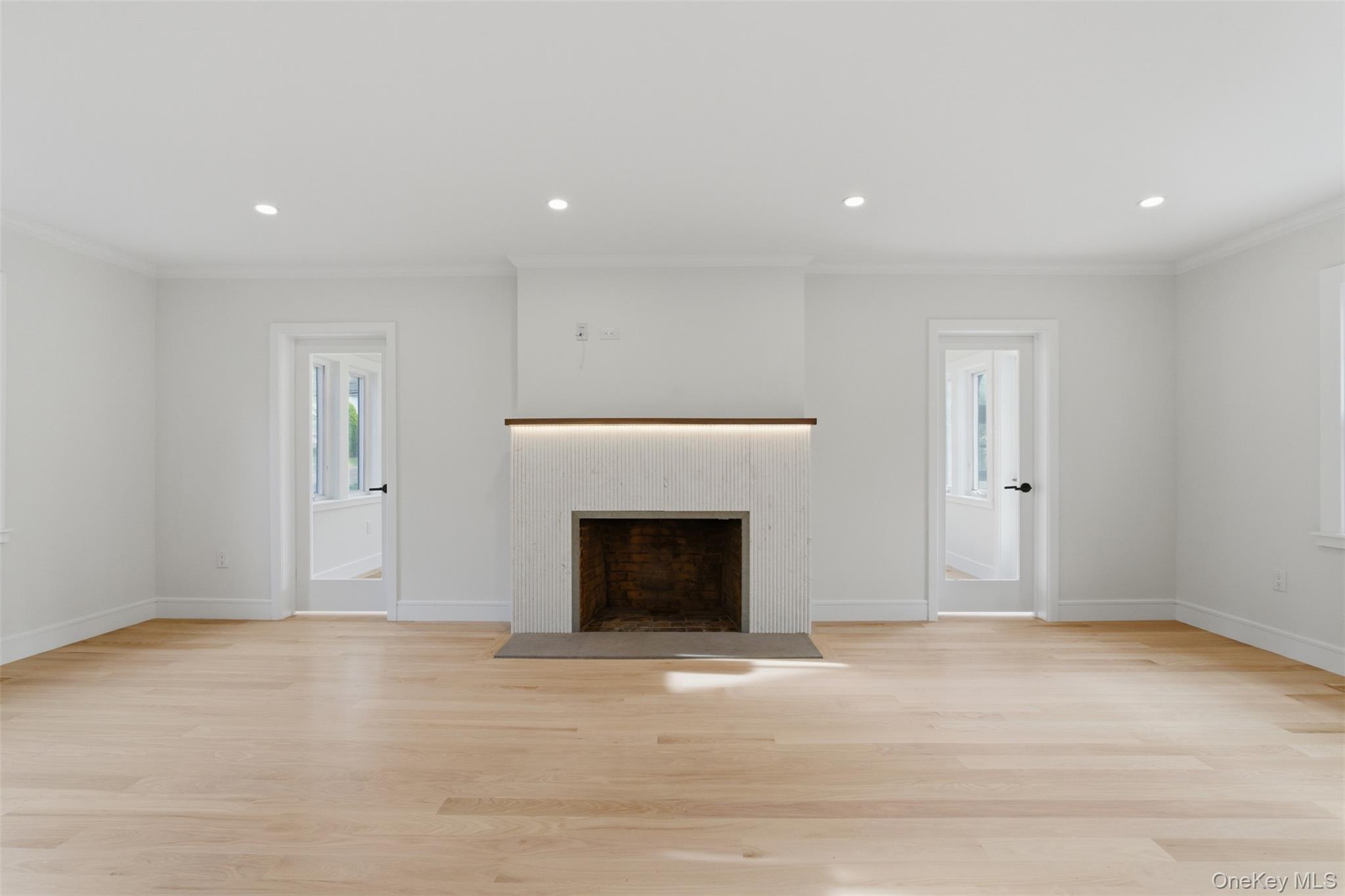 40 Calhoun Avenue New Rochelle, NY 10801 - Photo 12 of 49 Spacious room featuring a stone-clad fireplace with a wood mantle and integrated lighting