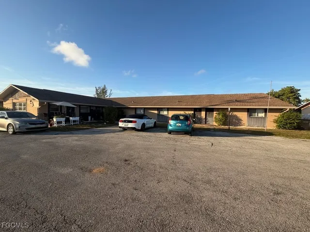 a kitchen with stainless steel appliances a refrigerator a sink a stove and white cabinets