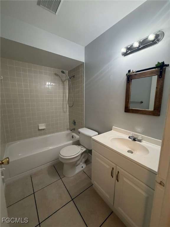 817 Gleason Parkway, Unit 3 Cape Coral, FL 33914 - Photo 12 of 12 a bathroom with a toilet a sink a mirror a bathtub and shower