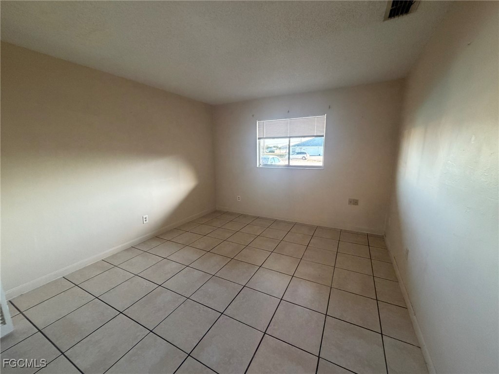 817 Gleason Parkway, Unit 3 Cape Coral, FL 33914 - Photo 3 of 12 an empty room with windows